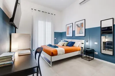 a bedroom with a king sized bed and a desk at BDC - Stairway to Heaven in Rome