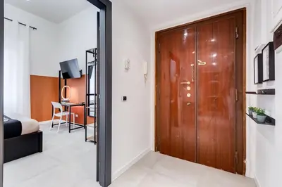 a hallway with a wooden door and a bedroom at BDC - Stairway to Heaven in Rome