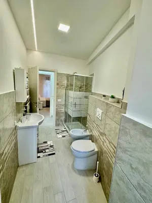 a bathroom with a toilet and a sink at holiday home modern 2 rooms near colosseo in Rome