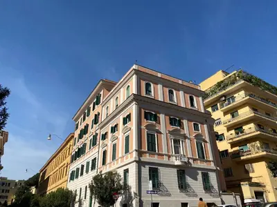 a tall white building in front of a building at Casa per Ferie Suore Salesiane dei Sacri Cuori in Rome