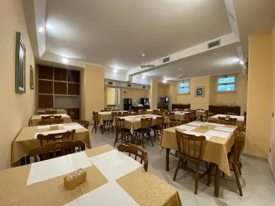 an empty dining room with tables and chairs at Casa per Ferie Suore Salesiane dei Sacri Cuori in Rome