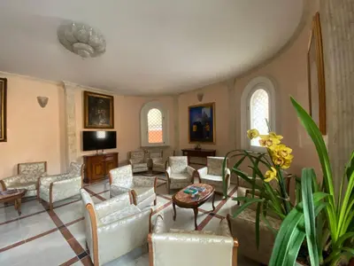a large living room with chairs and a table at Casa per Ferie Suore Salesiane dei Sacri Cuori in Rome