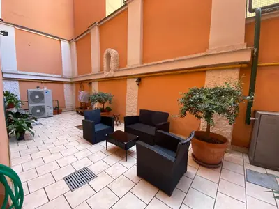 an empty lobby with couches and chairs and plants at Casa per Ferie Suore Salesiane dei Sacri Cuori in Rome