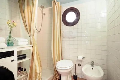a bathroom with a toilet and a sink at TrastevereHome - Secret Balcony in the Heart of Rome Trastevere in Rome