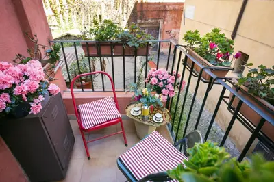 a balcony with a bunch of plants and flowers at TrastevereHome - Secret Balcony in the Heart of Rome Trastevere in Rome