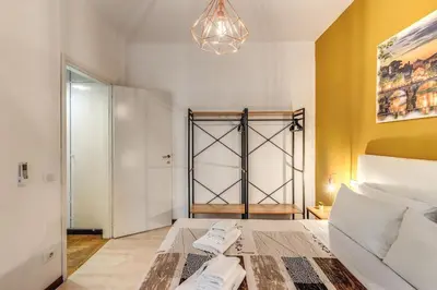 a bedroom with a bed and a chandelier at Dimora Lunetta - Modern Flat in Vatican District in Rome