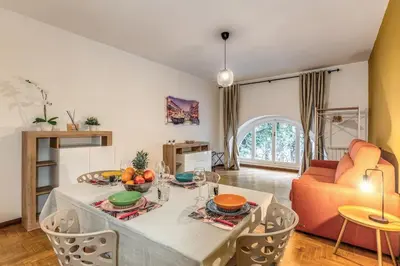 a living room with a table and a couch at Dimora Lunetta - Modern Flat in Vatican District in Rome