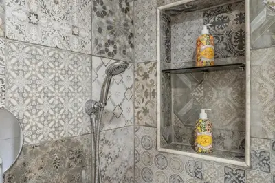 a bathroom with a shower and a mirror at Dimora Lunetta - Modern Flat in Vatican District in Rome