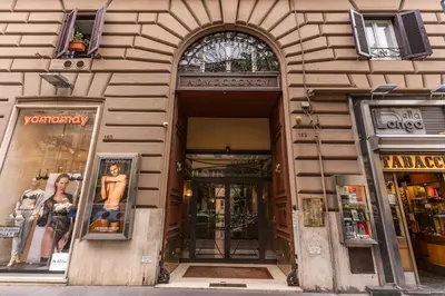 a building with two entrances to a store with windows at Dimora Lunetta - Modern Flat in Vatican District in Rome