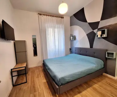 a bedroom with a bed with a geometric wall at Casa Laila in Rome