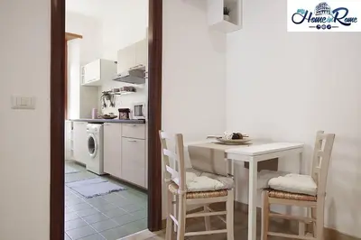 a kitchen with a table and chairs in a kitchen at Holy Vatican Home in Rome