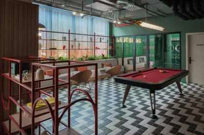 a room with a pool table and some chairs at The Social Hub Rome Extended Stay in Rome