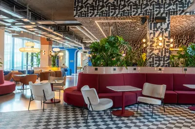 a lobby with a red couch and chairs at The Social Hub Rome Extended Stay in Rome