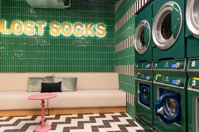a waiting room with a bench and washing machines at The Social Hub Rome Extended Stay in Rome