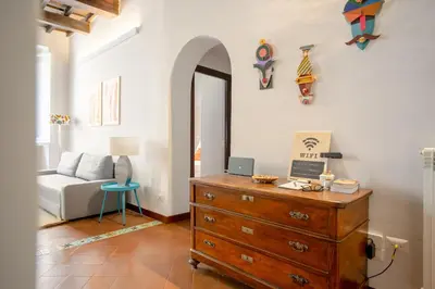 a living room with a dresser and a mirror at Trastevere 2 Badrooms Design Appartment in Rome