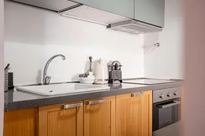 a kitchen with a sink and a stove at Trastevere 2 Badrooms Design Appartment in Rome
