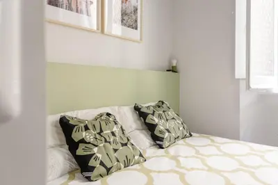 a bed with two pillows on top of it at Trastevere 2 Badrooms Design Appartment in Rome