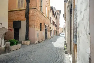 an empty alley with buildings and a stone street at Trastevere 2 Badrooms Design Appartment in Rome