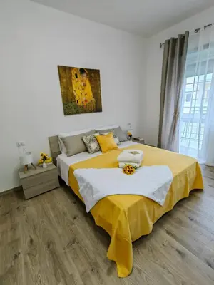 a bedroom with a large bed with yellow sheets at B&B Gregorio VII in Rome