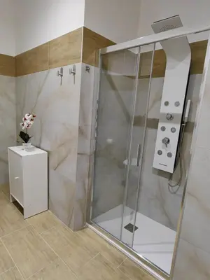 a shower with a glass door in a bathroom at B&B Gregorio VII in Rome