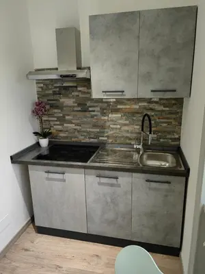 a kitchen with a sink and a counter top at B&B Gregorio VII in Rome