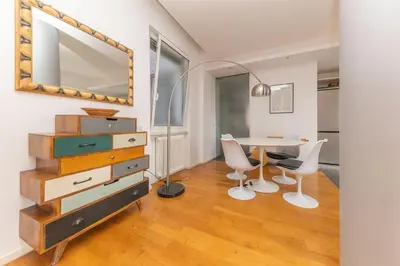 a dining room with a table and chairs and a mirror at Elegant house in Monteverde in Rome