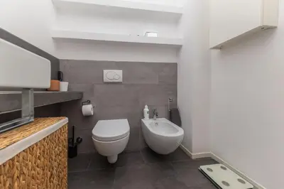 a small bathroom with a toilet and a sink at Elegant house in Monteverde in Rome