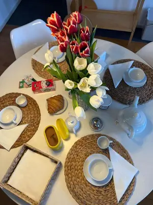 a table with a vase of flowers on it at Elegant house in Monteverde in Rome