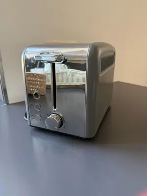 a silver toaster sitting on top of a table at Elegant house in Monteverde in Rome