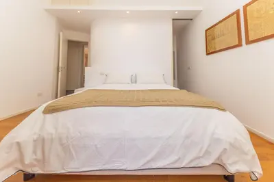 a large white bed in a white bedroom at Elegant house in Monteverde in Rome