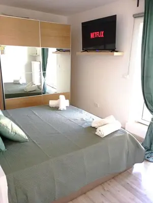 a bedroom with a bed with a tv on the wall at Jeb's Sweet Rooftop in Rome