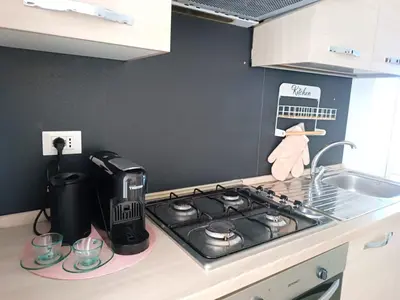 a kitchen counter with a stove and a sink at Jeb's Sweet Rooftop in Rome