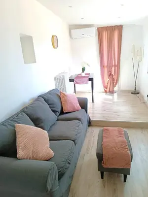a living room with a couch and a table at Jeb's Sweet Rooftop in Rome
