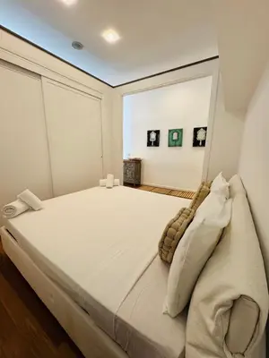 a bedroom with a large white bed in a room at Suite Eroi in Rome