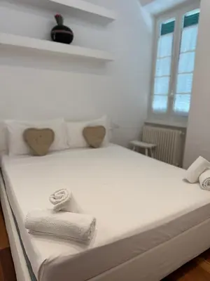 a white bed with towels on top of it at Suite Eroi in Rome