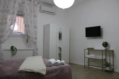 a bedroom with a bed with pillows and a television at Apartment near the Vatican in Rome