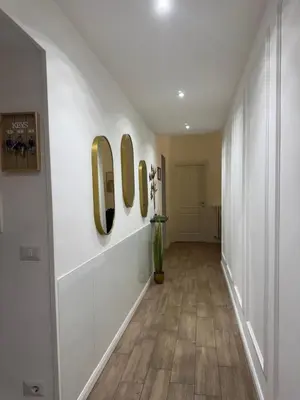 a hallway with three mirrors on the wall at Apartment near the Vatican in Rome