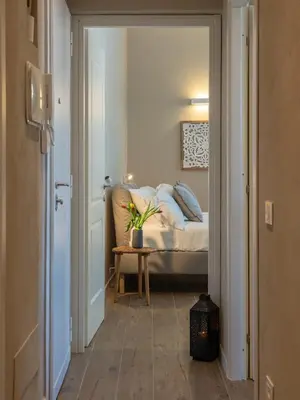 a bedroom with a bed and a table with a plant at Penthouse Vado Collection in Rome