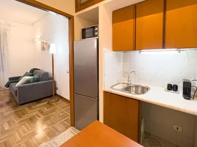a kitchen with a sink and a couch in a room at Braliu Apartment in Rome