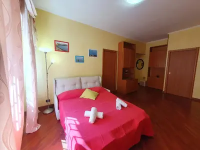 a bedroom with a red bed with two teddy bears on it at Domus Monteverde in Rome