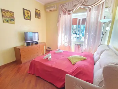 a living room with a pink bed and a couch at Domus Monteverde in Rome
