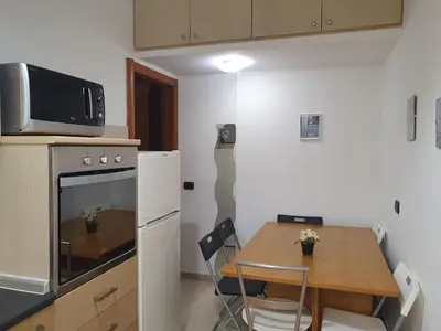 a small kitchen with a table and a small kitchen with a small table at Domus Monteverde in Rome