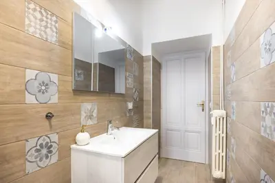 a bathroom with a white sink and a mirror at Casa Minieri - Viale Mazzini - San Pietro in Rome
