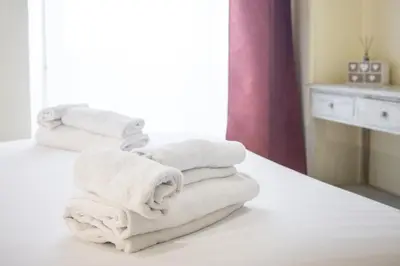a pile of towels sitting on top of a bed at Casa Minieri - Viale Mazzini - San Pietro in Rome