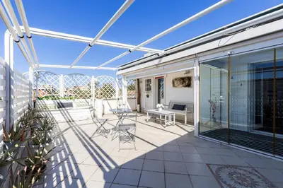 a patio with chairs and a table on a house at Hostly-Salotti Terrace Suite-20min to Vatican in Rome