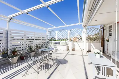 a balcony with chairs and plants on a building at Hostly-Salotti Terrace Suite-20min to Vatican in Rome