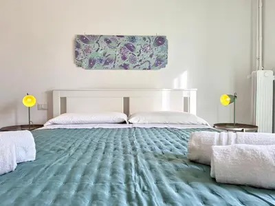 a bedroom with a large bed with a blue carpet at La Dolce Vita - Roman Experience in Rome