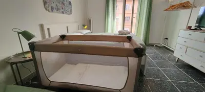 a small bedroom with two beds and a dresser at La Dolce Vita - Roman Experience in Rome