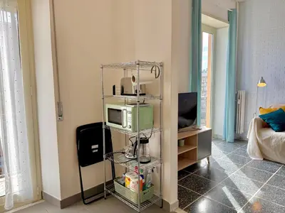 a living room with a tv and a microwave at La Dolce Vita - Roman Experience in Rome