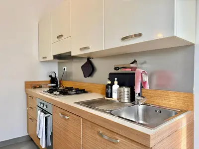 a kitchen with a sink and a stove at La Dolce Vita - Roman Experience in Rome